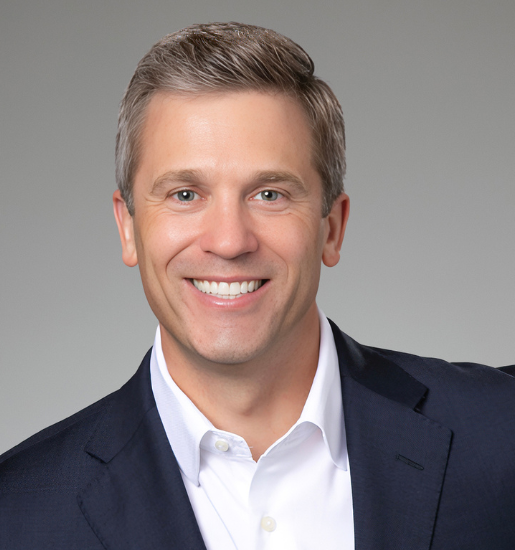 Smiling man in navy blazer and white shirt