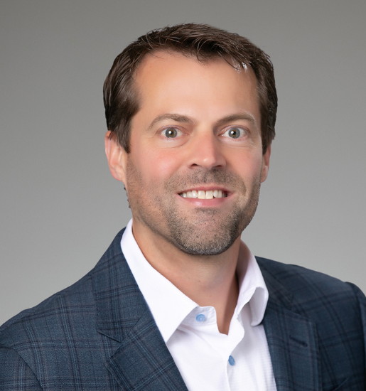Professional headshot of man in blue blazer