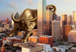 Giant bull sculpture over city skyline