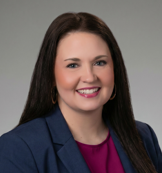 Professional woman smiling in studio headshot
