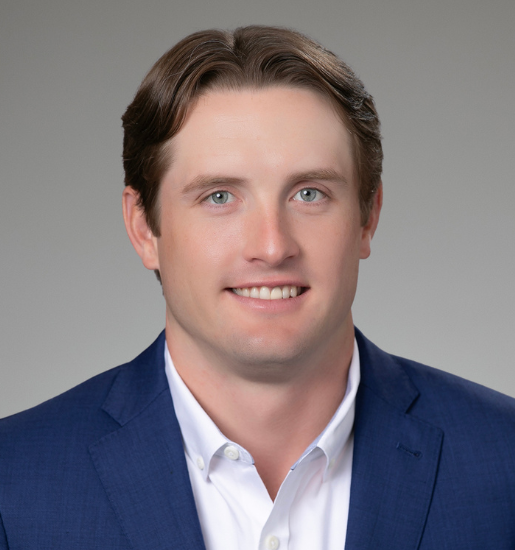 Professional headshot of man in blue suit