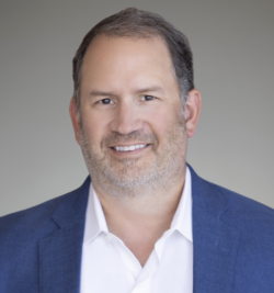 Smiling middle-aged man in blue blazer headshot